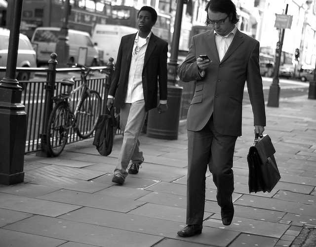 businessman checking email while walking