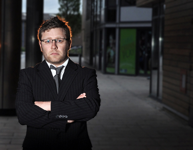 man in a suit with crossed arms