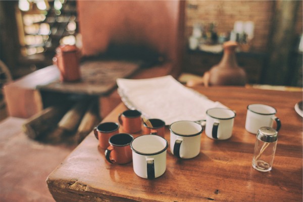 line of coffee cups on a table