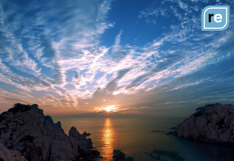 Sunset over the ocean with dramatic clouds, reflecting on rational decisions and clarity in the age of AI.