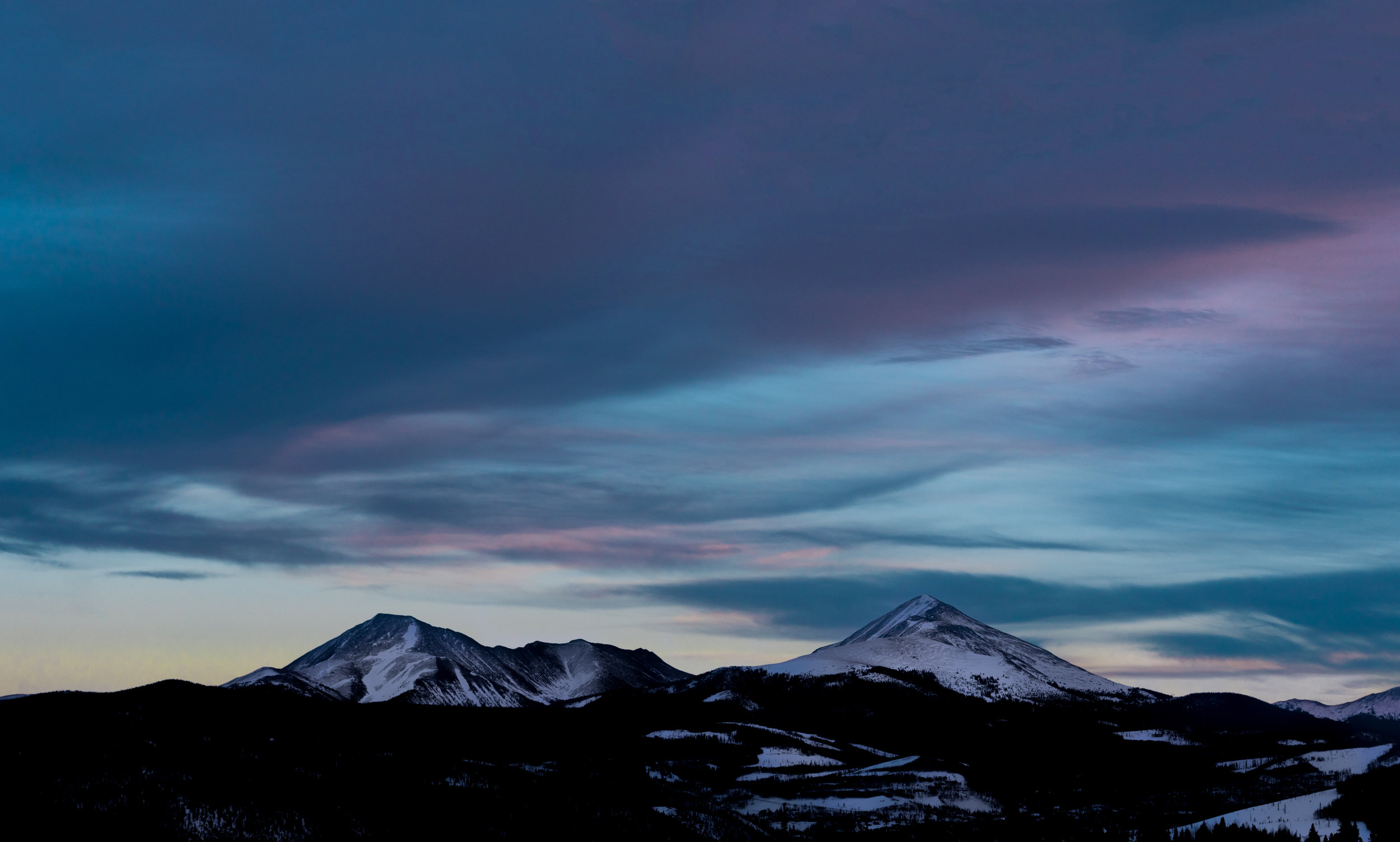 Snow-capped mountains at dusk, symbolizing the peaks of AI leadership in navigating career challenges.