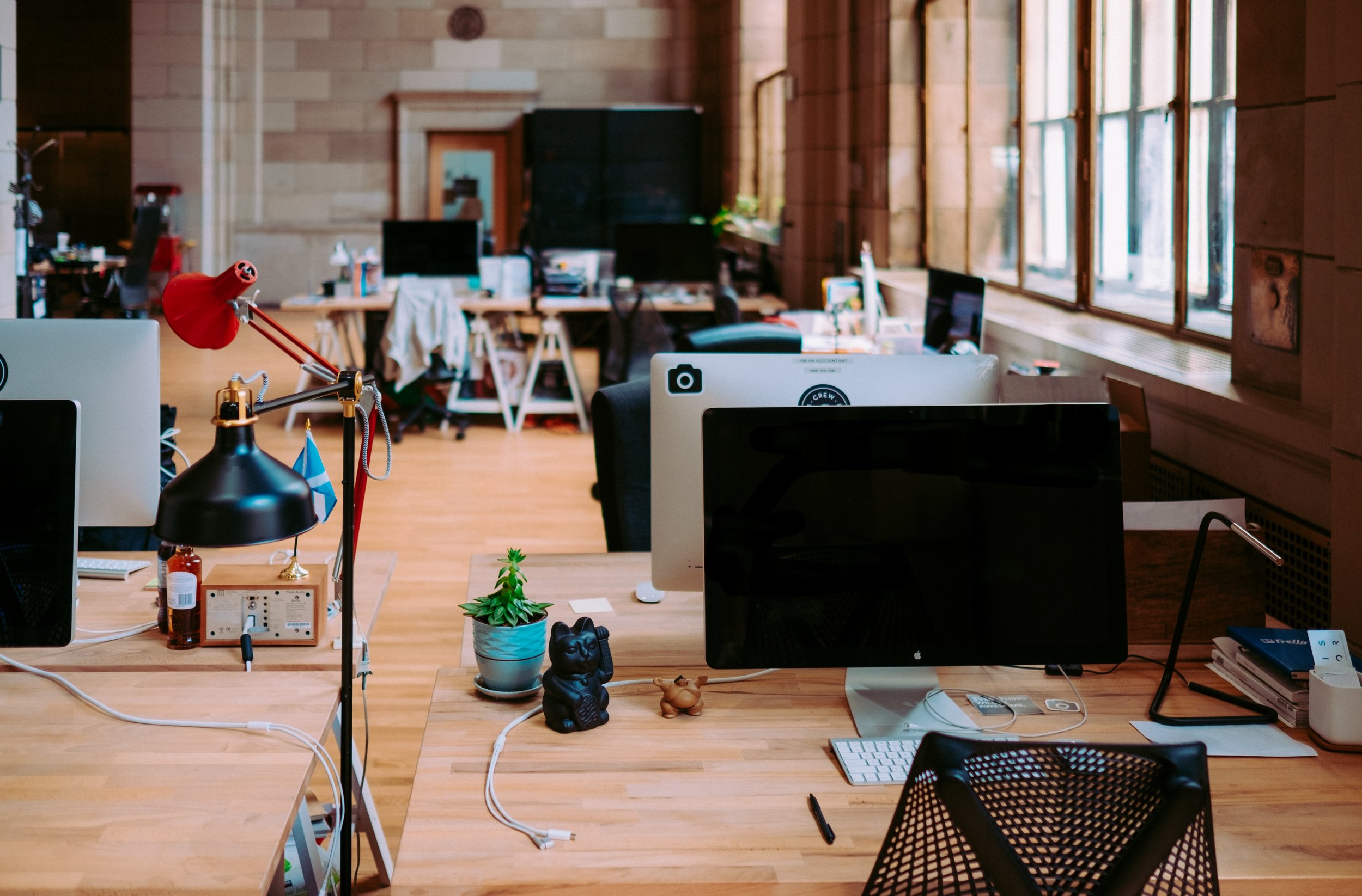 Creative workspace with multiple workstations, emphasizing the pitfalls of open office communication.